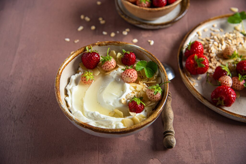 Bowl of yogurt and honey with strawberries. 