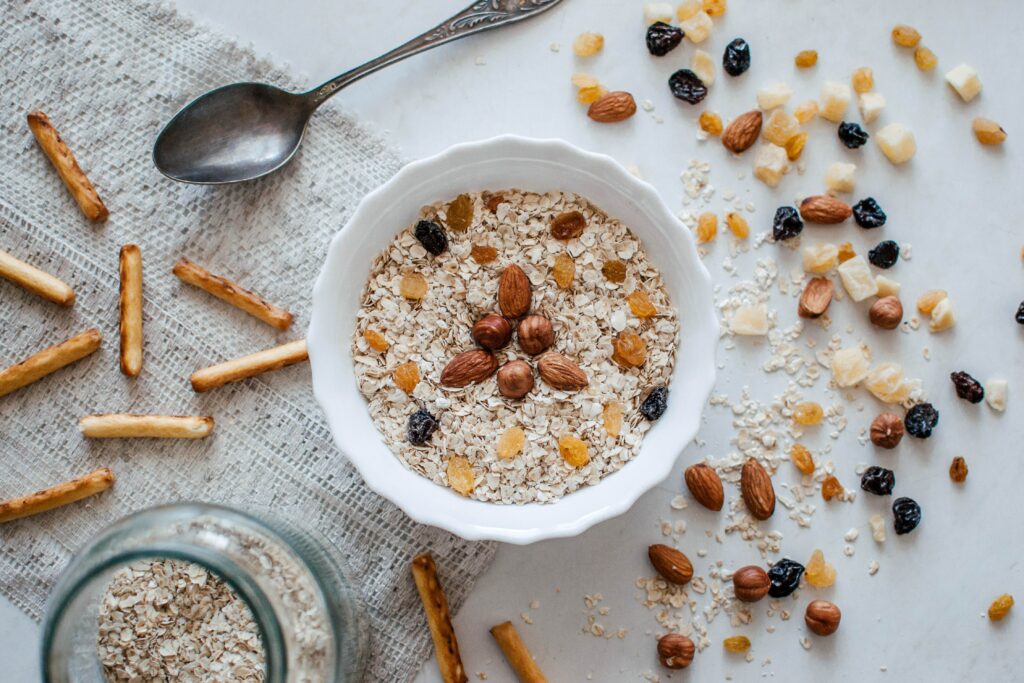 Female nutrition: bowl of oats with raisins, almonds, and other grains. 