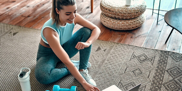 A,Sporty,Woman,In,Sportswear,Is,Sitting,On,The,Floor