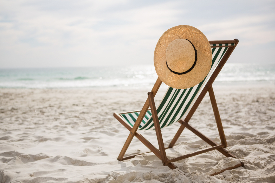 straw-hat-kept-empty-beach-chair-darling-magazine-article-summer-holidays